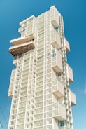 a tall white building with balconies and windows