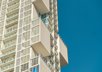 a tall building with balconies on the top of it