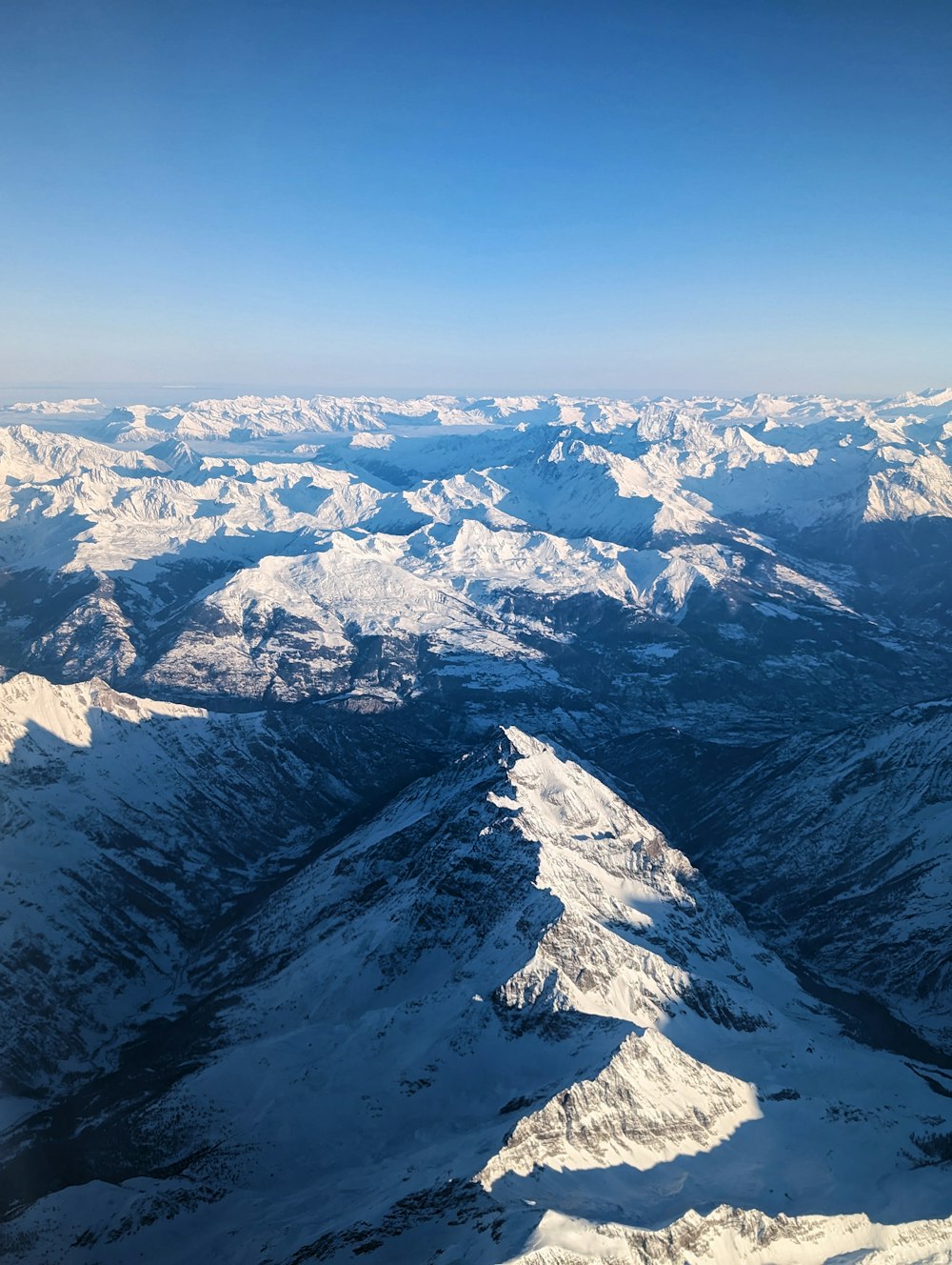 a view of snow covered mountains from an airplane