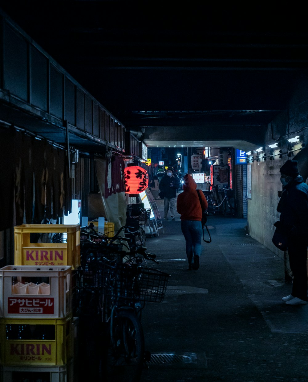 a person walking down a dark alley way