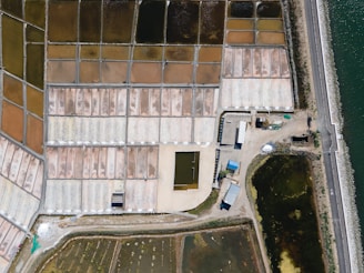 an aerial view of a building next to a body of water