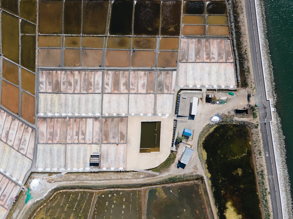 an aerial view of a building next to a body of water