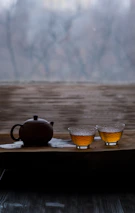 a tea pot and two cups on a tray