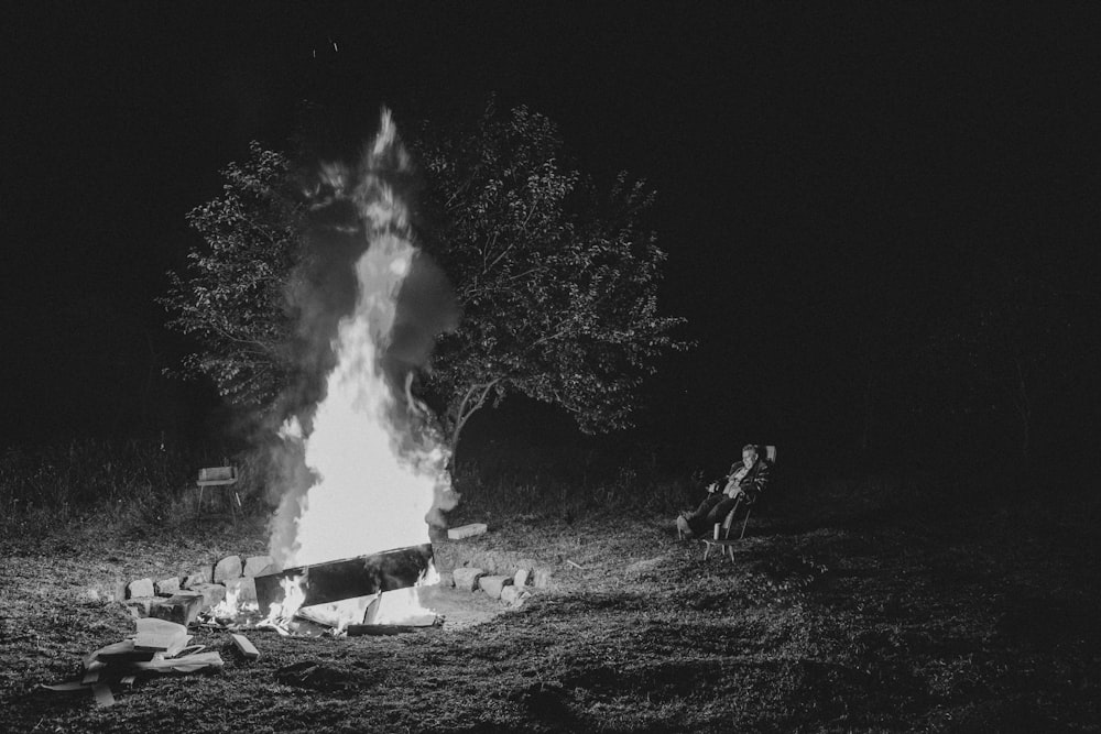 a person sitting in front of a fire pit