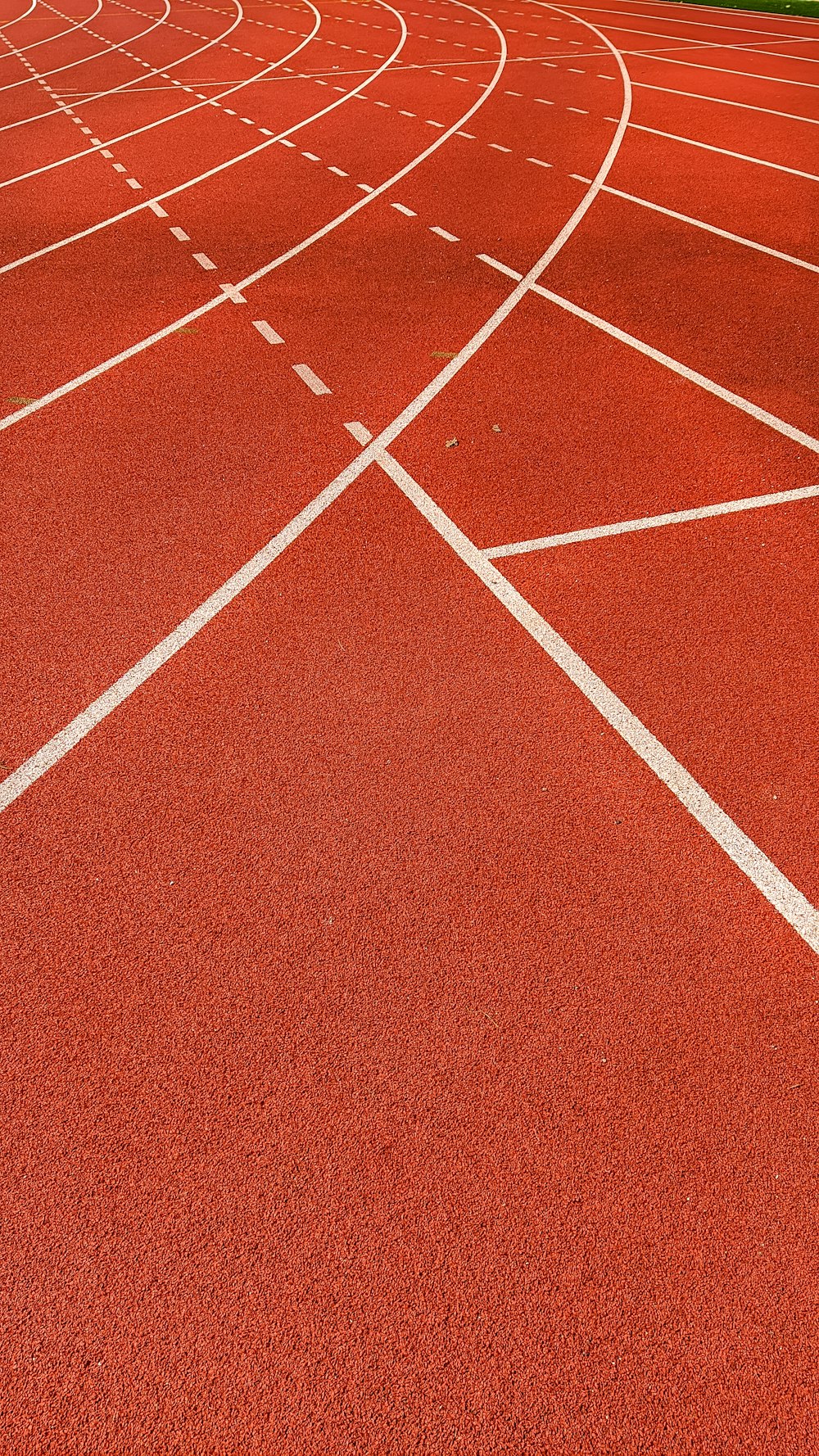 a red running track with white lines on it