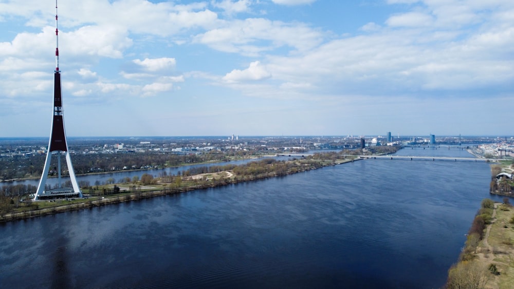 an aerial view of a river and a tower