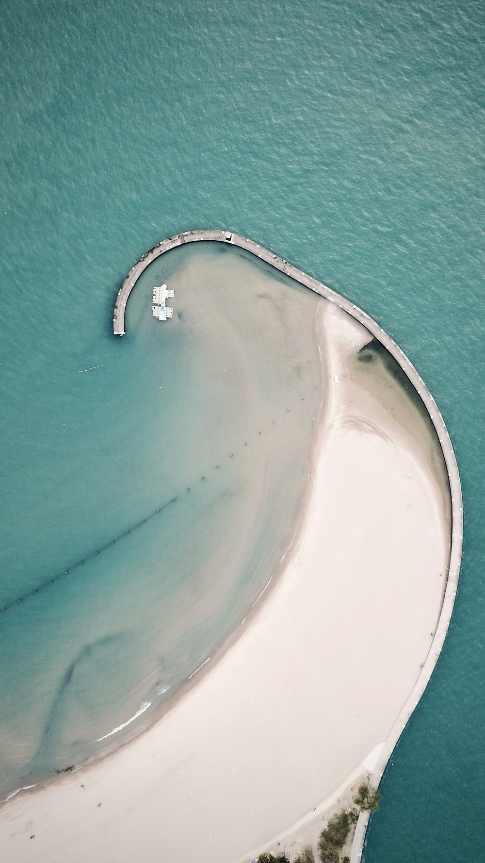 an aerial view of a white sandy beach
