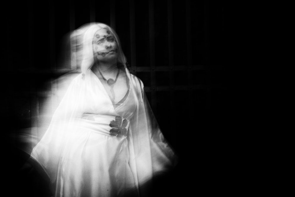 a black and white photo of a woman in a veil