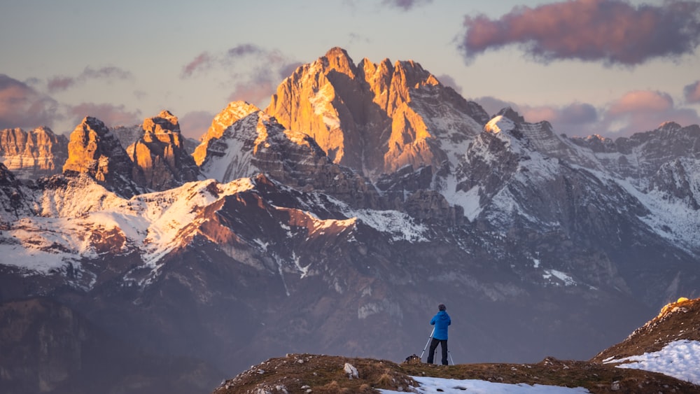 a man standing on top of a snow covered mountain