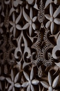 Close-up of a wooden plaque with intricate laser-engraved floral patterns.