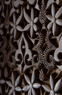 A detailed laser-cut floral pattern on wood, showcasing intricate design and precision.