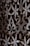 Intricate floral and geometric patterns are carved into a wooden surface. The design features overlapping flowers and swirling shapes, with detailed engraving work that adds depth and texture.