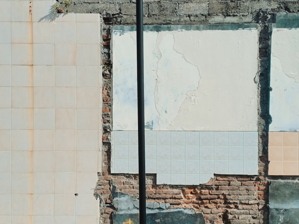 a brick wall with a street light next to it