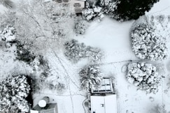 an aerial view of a house in the snow
