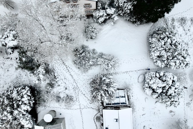 an aerial view of a house in the snow