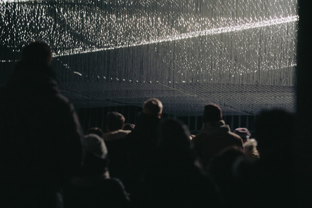 a group of people standing in a dark room