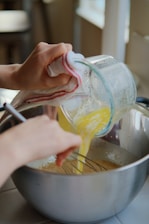 a person is mixing something in a pot