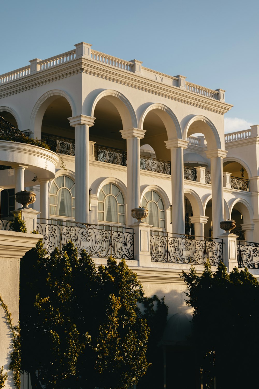 a large white building with a balcony and balconies