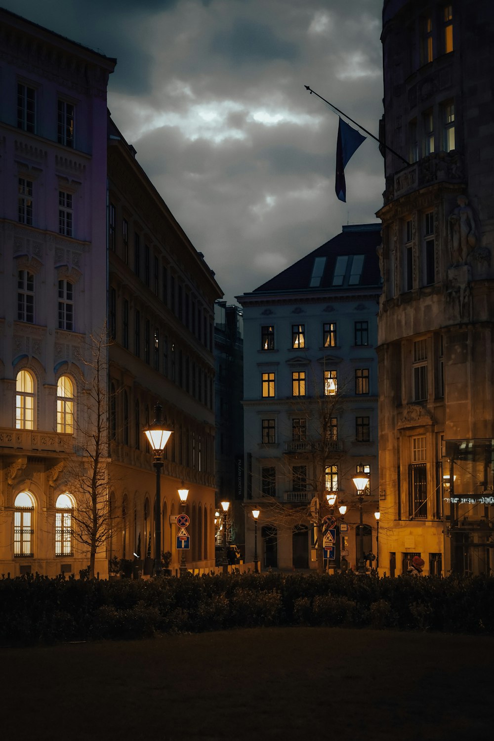 a city street at night with buildings lit up