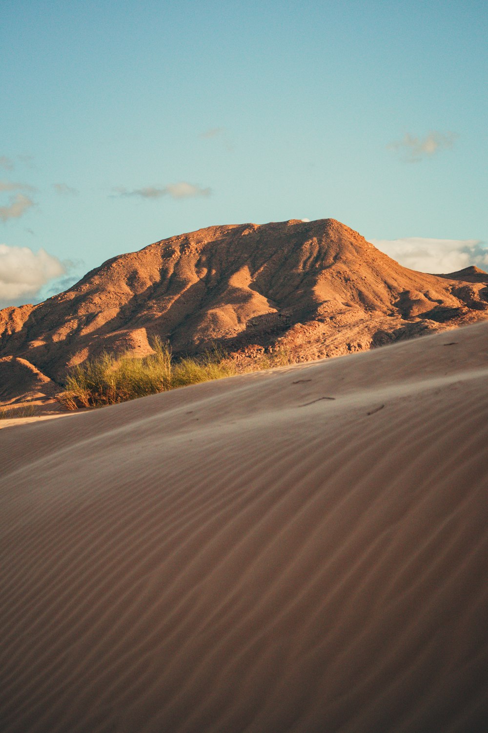 a mountain in the distance with a desert landscape