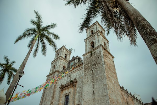 A tall tower with a clock on the top of it — Valladolid, Mexico
