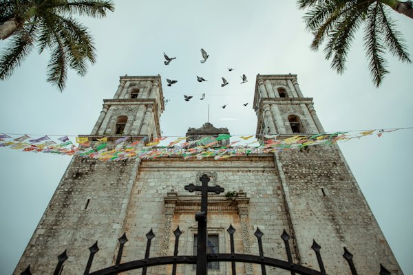 A tall tower with a clock on it's side — Valladolid, Mexico