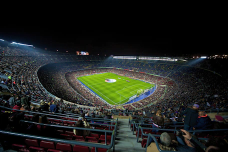 A dynamic football match scene with players competing fiercely under stadium lights.
