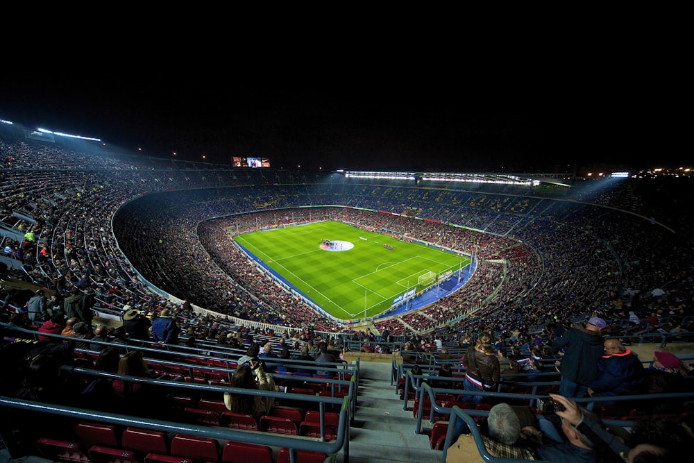 a stadium filled with lots of people watching a soccer game