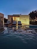 a house with a swimming pool at night