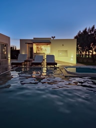 a house with a swimming pool at night
