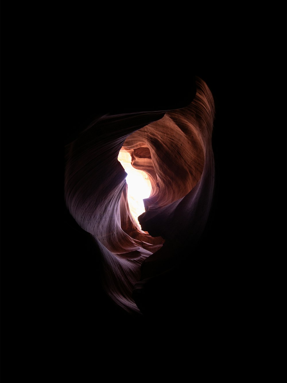 a large rock formation with a light at the end of it