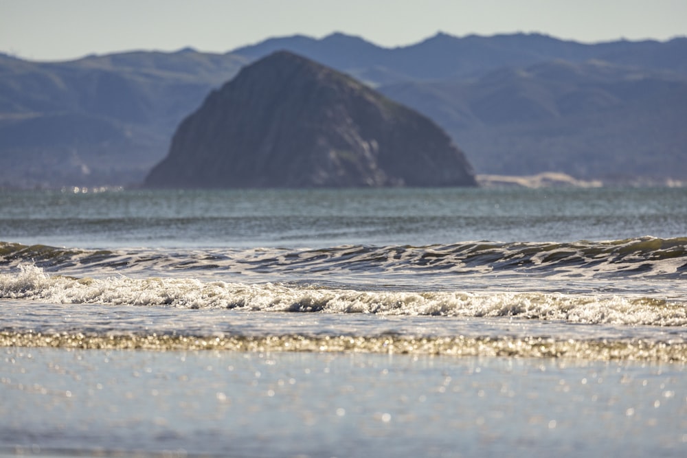 a man riding a wave on top of a surfboard