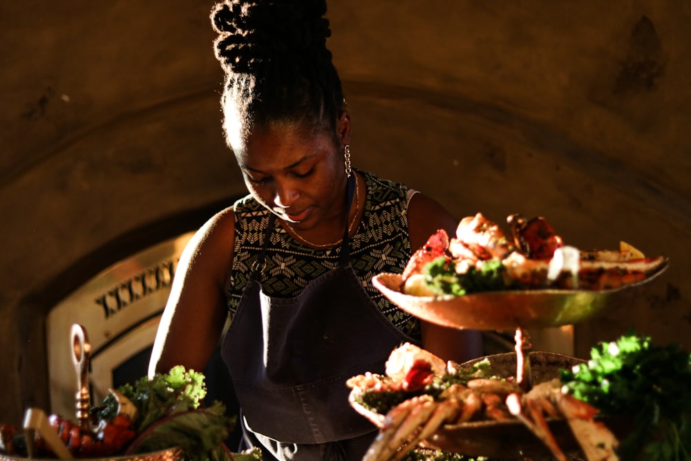a woman standing in front of plates of food