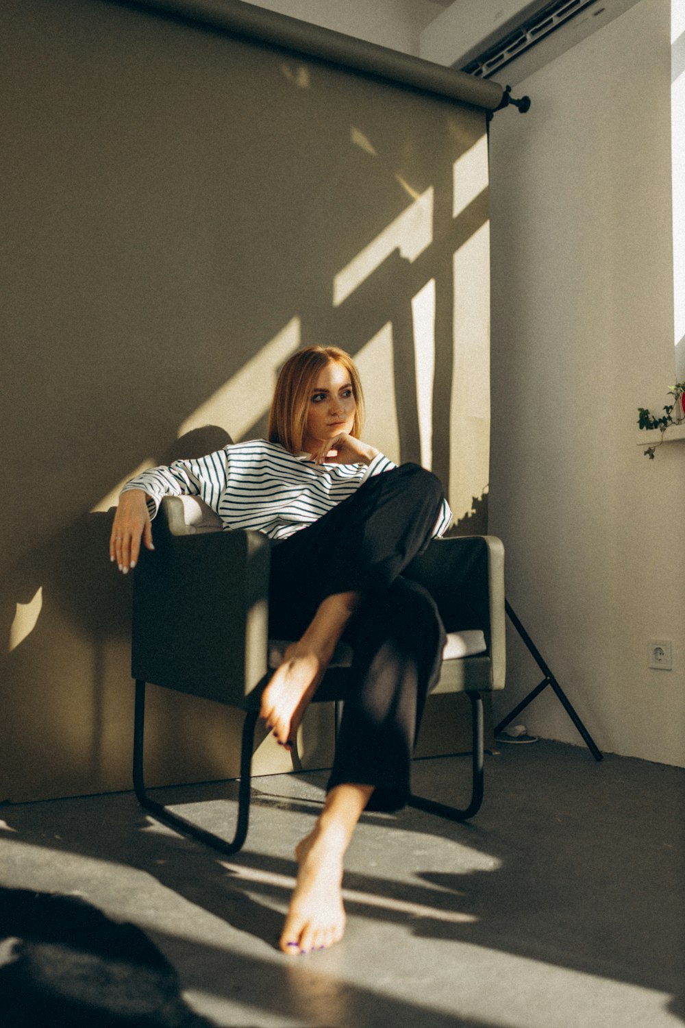 une femme assise sur une chaise dans une pièce