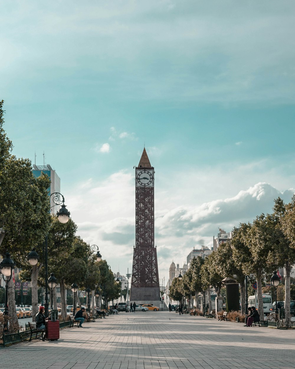 a large clock tower towering over a city street