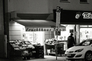Front view of Asian Supermarkt Afro Shop Malus storefront with bright orange signage and welcoming entrance.