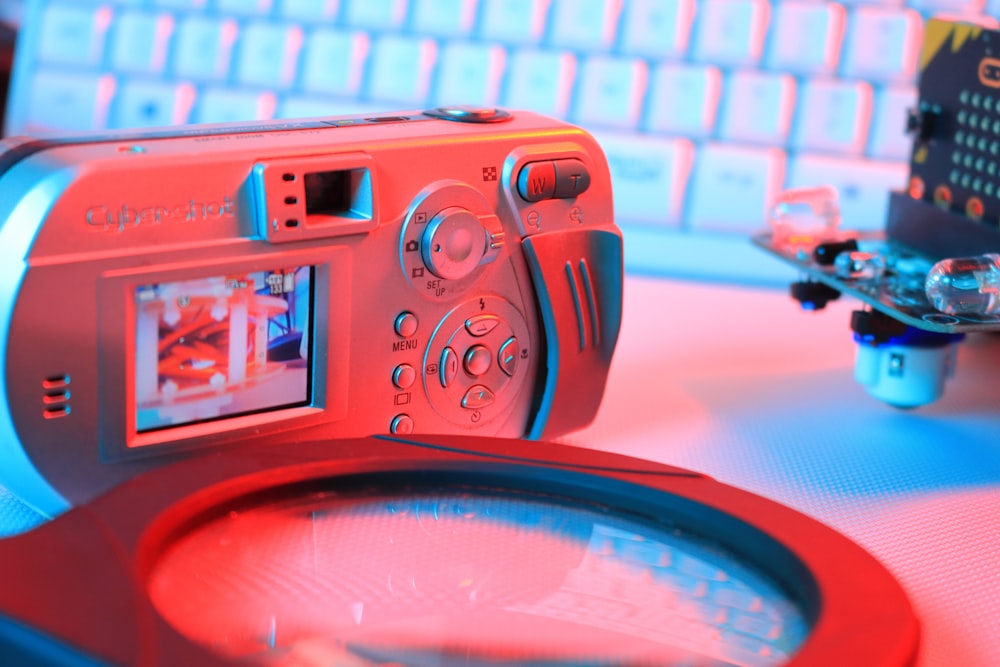 a camera sitting on top of a table next to a keyboard