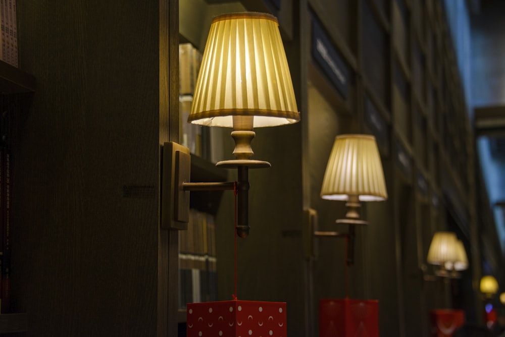 a row of lamps hanging from the side of a building