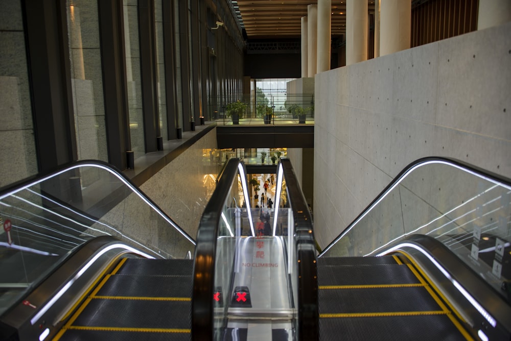 an escalator in a building with people on it