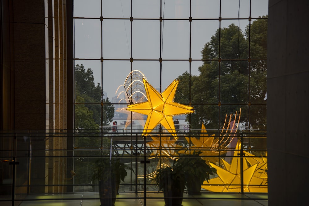 a large yellow star is seen through a window