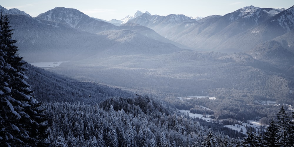 a view of a mountain range with snow on the trees