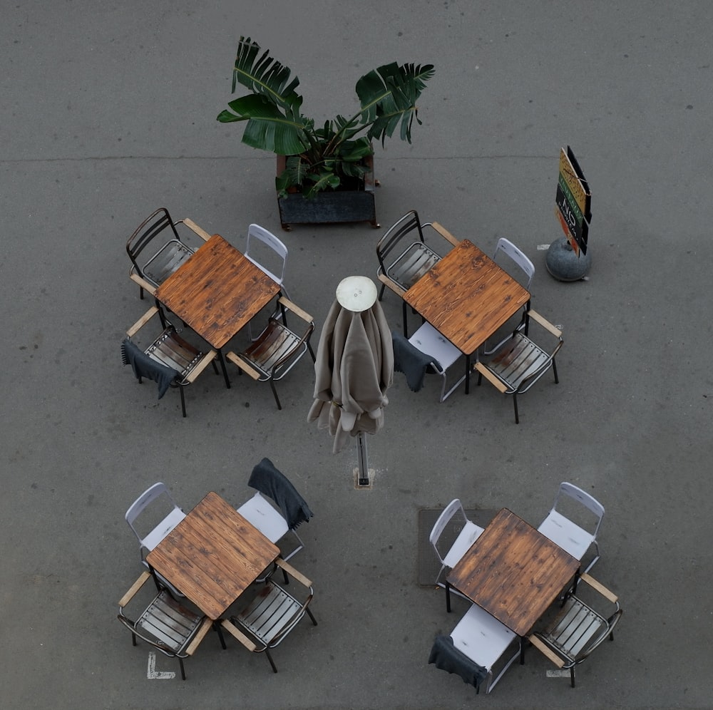 an overhead view of a table and chairs with an umbrella