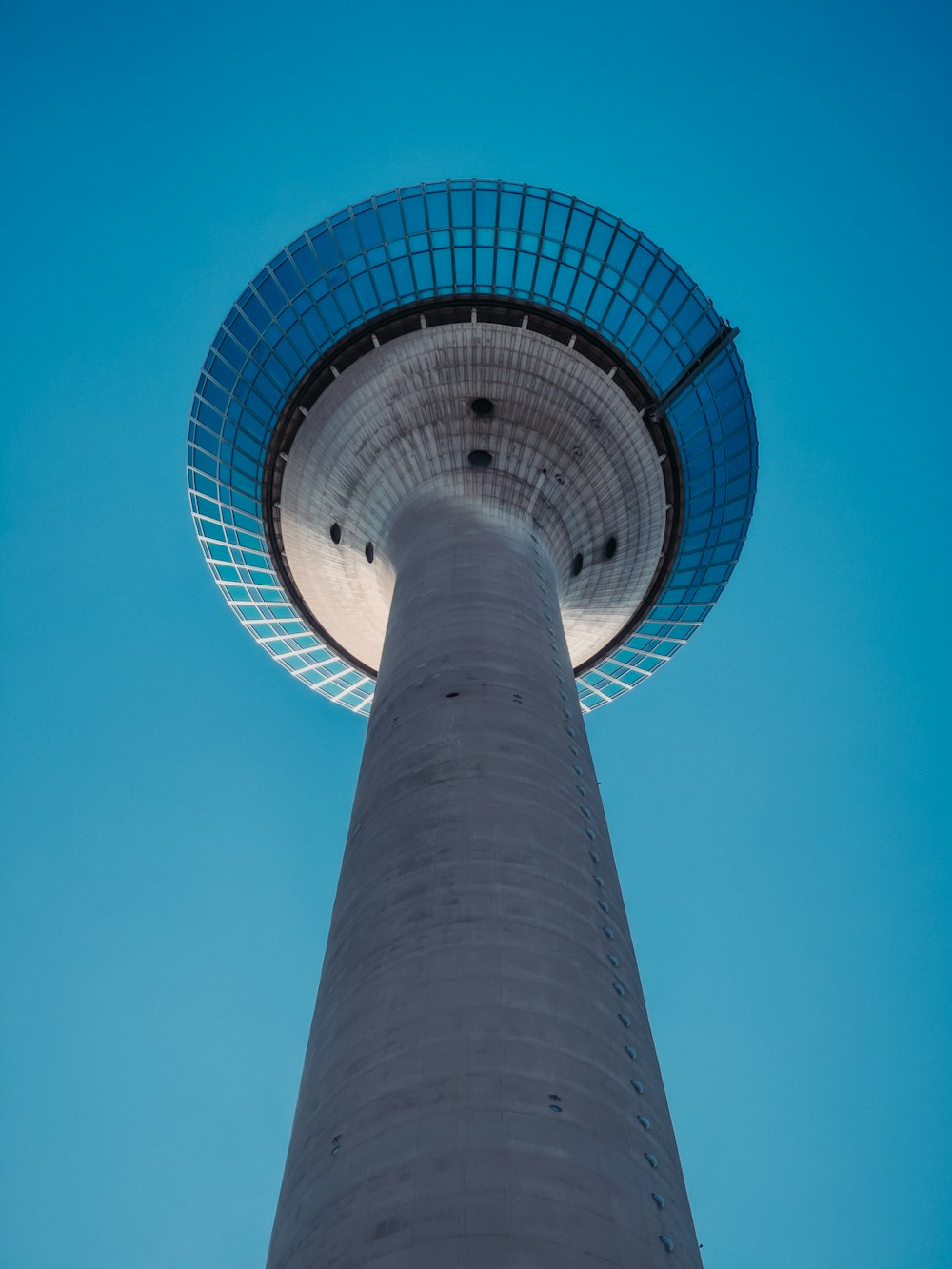 the top of a tall tower with a blue sky in the background