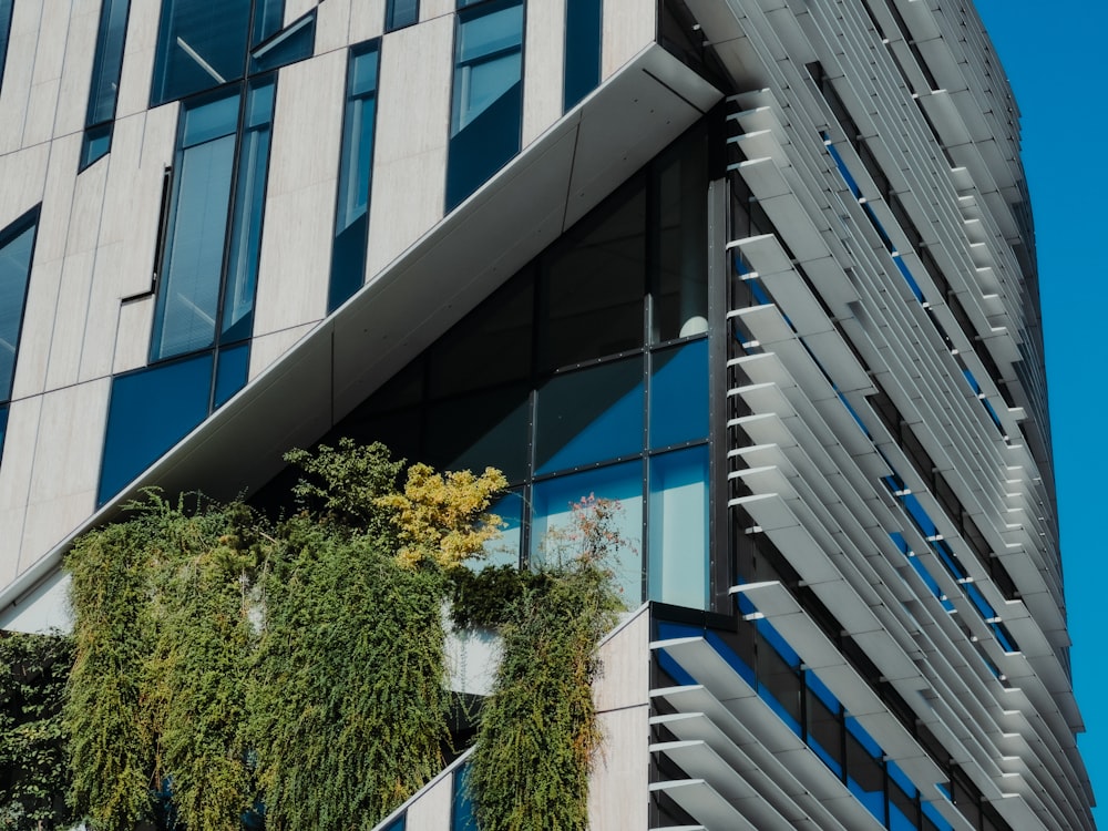 a tall building with plants growing on the side of it