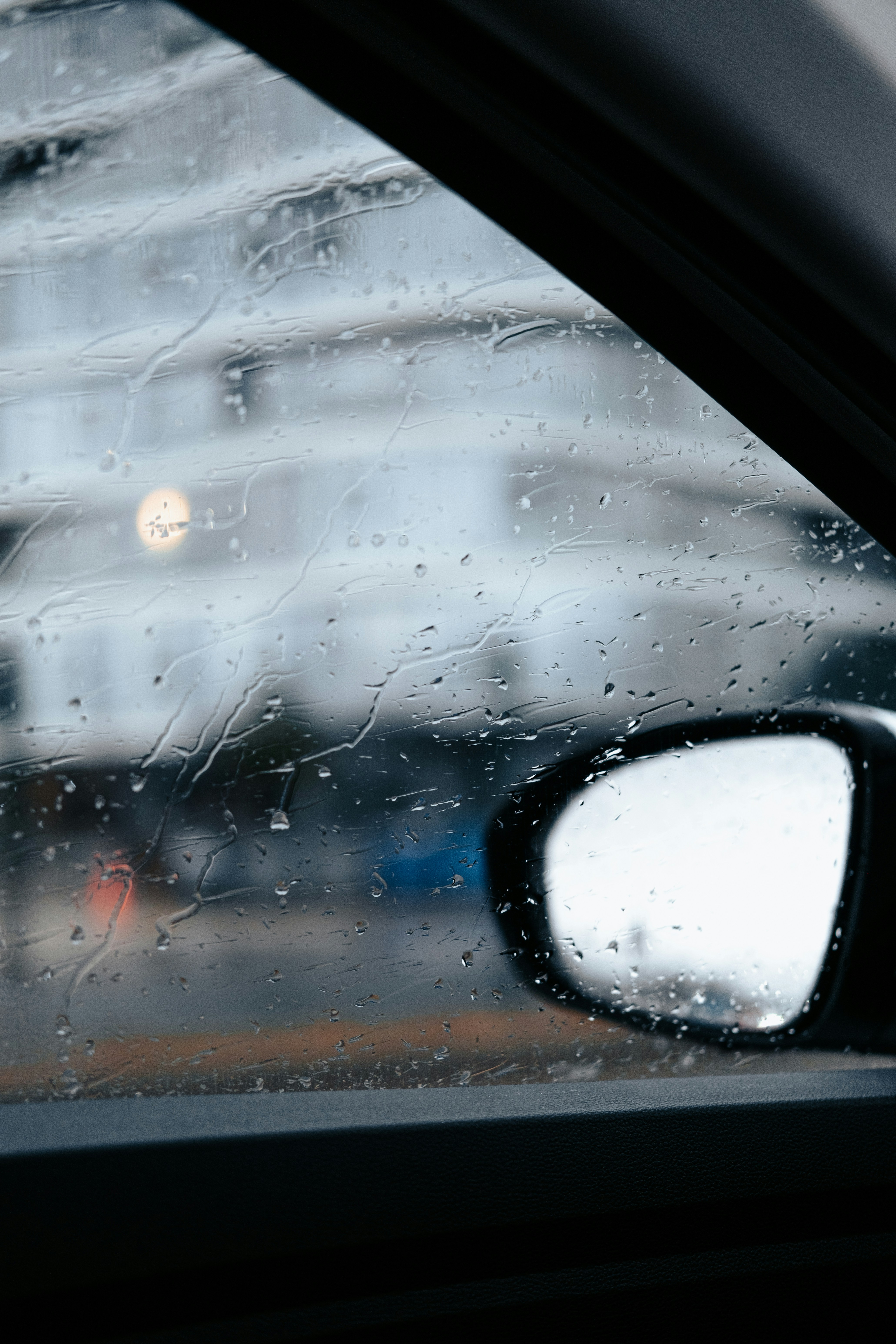 A car's side view mirror with rain drops on it photo – Free ...