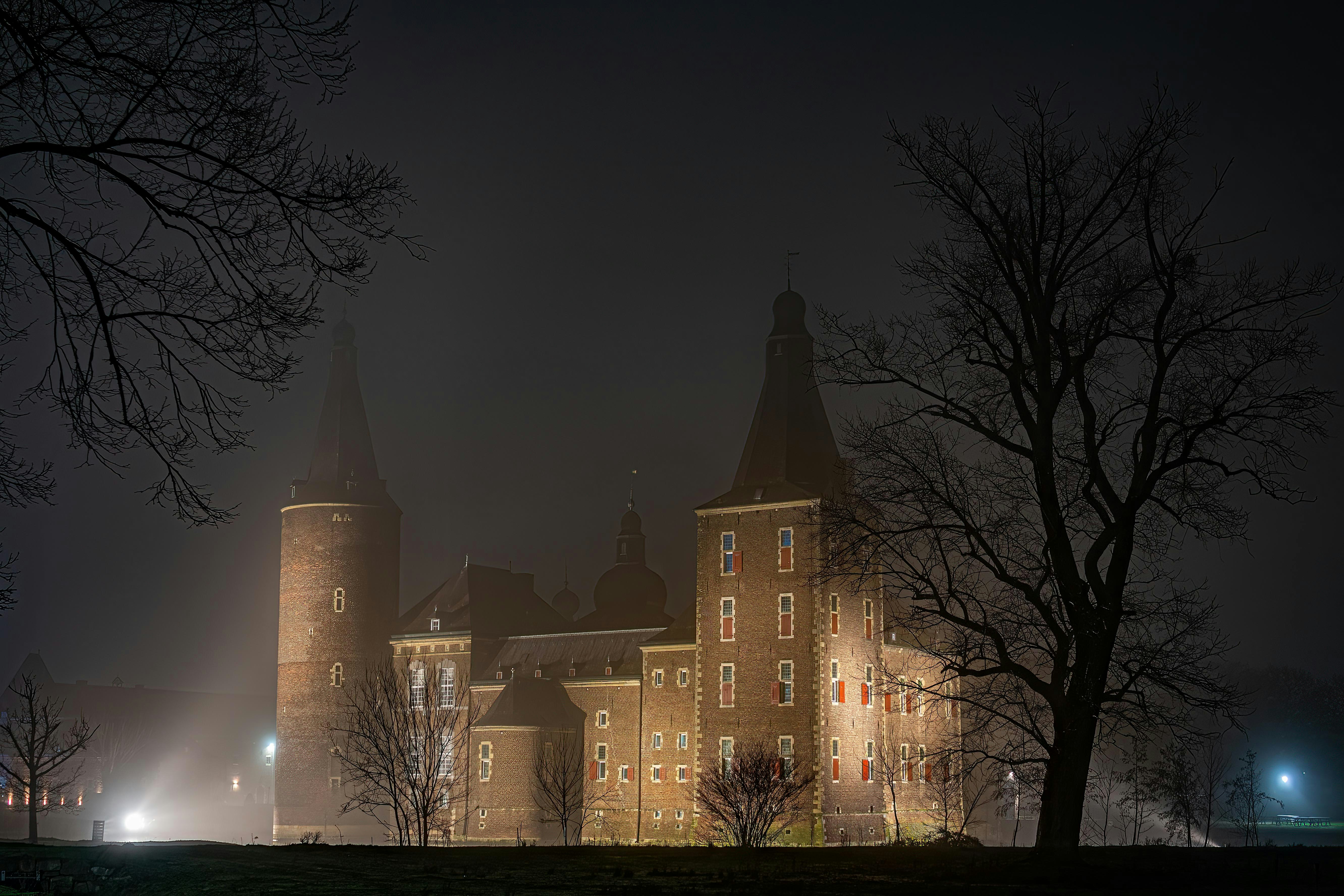 a large building with a clock tower at night