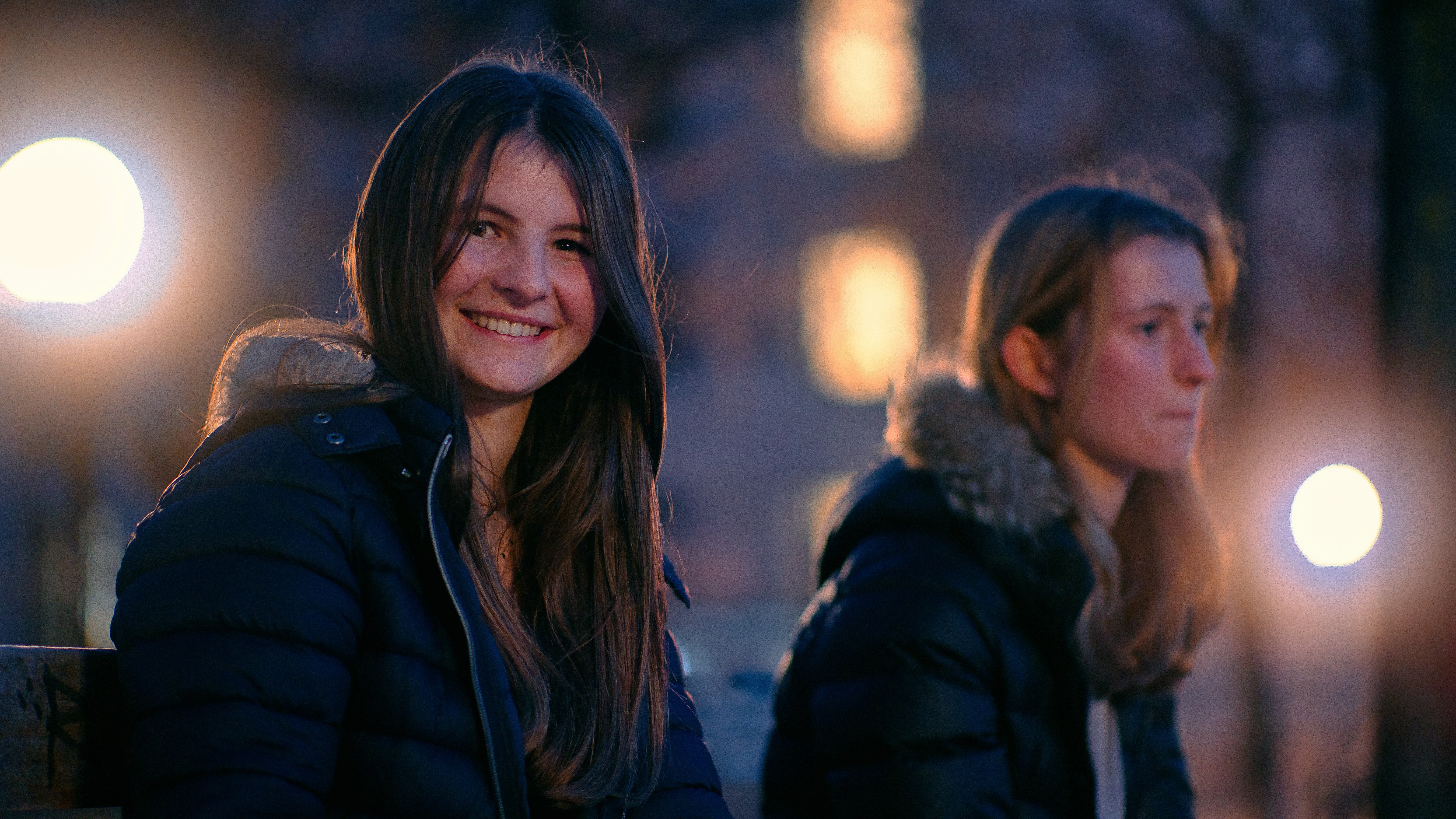 a couple of women sitting next to each other