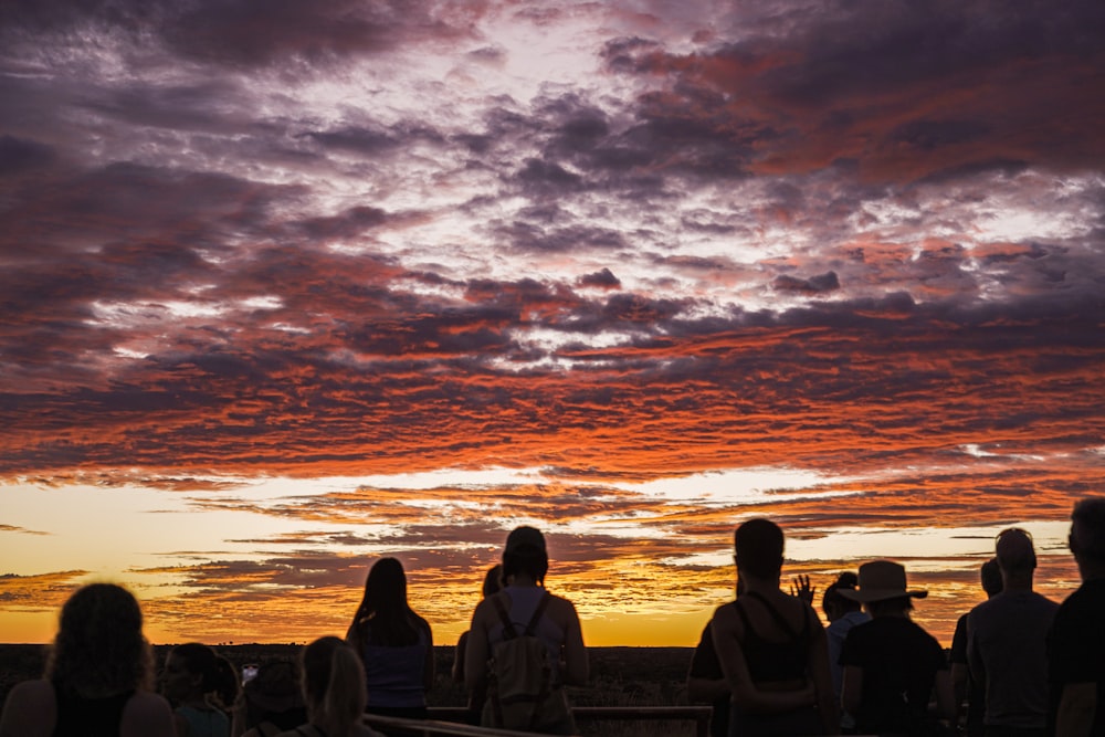 a group of people watching the sun set