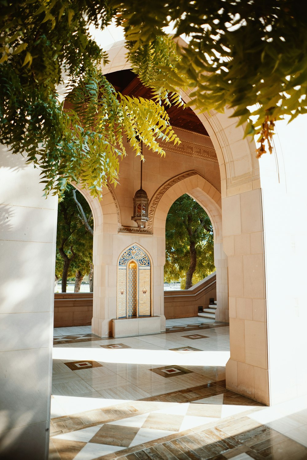 an archway leading to a building with a clock on it