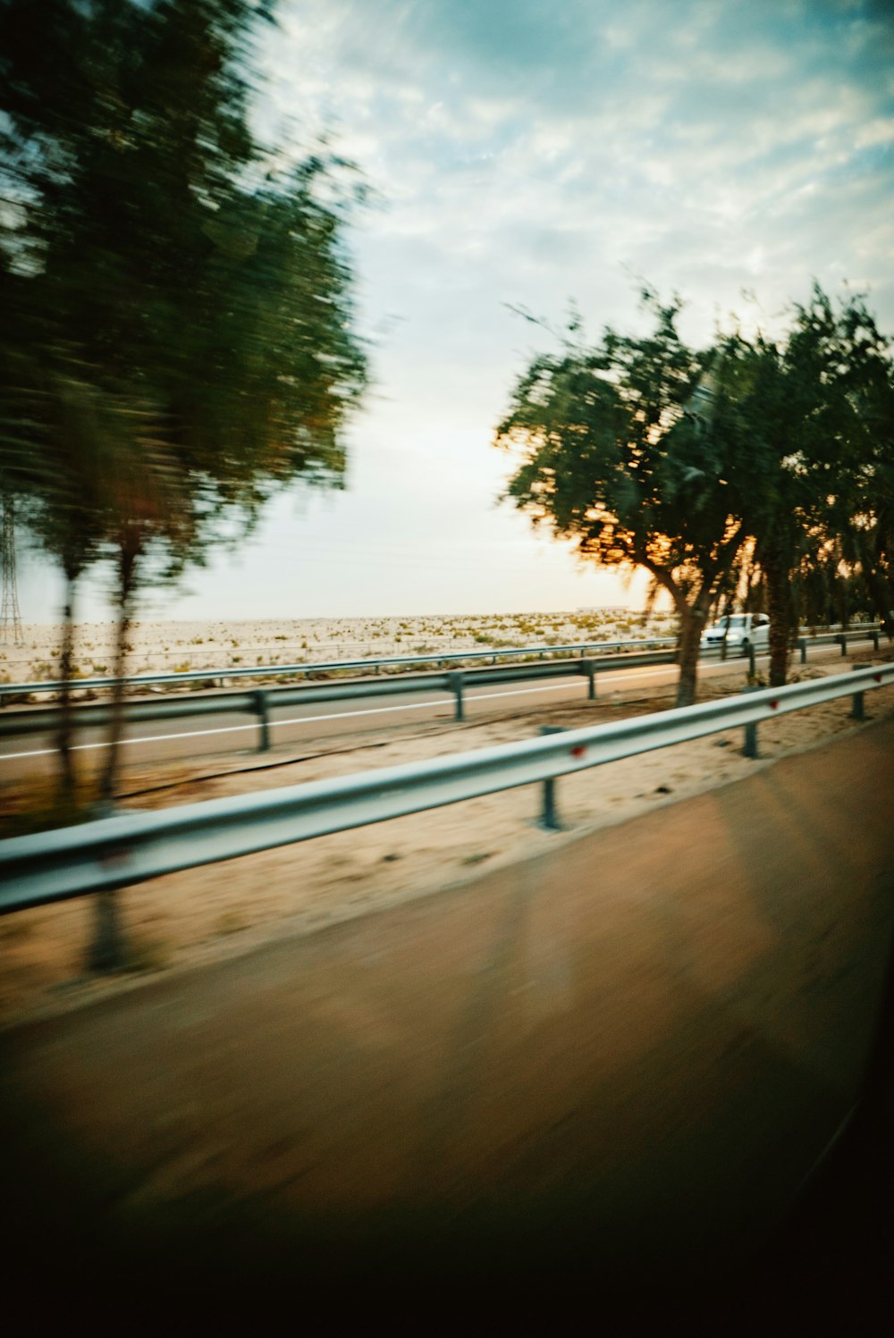 a blurry picture of a highway with trees on the side